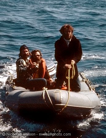 Greenpeace President Bob Hunter and two others in Zodiac prepare to board the Mendocino Whale War boat for a strategy meeting.