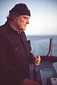 Byrd Baker at the helm of the Phyllis Cormack near sunset.