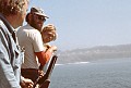 Byrd Baker, John Griffith and J.D. Mayhew on deck as the Mendocino Whale War boat Phyllis Cormack approaches Mendocino Bay  on July 4, 1976, for a quick visit during the Bicentennial celebration and Independence Day parade.