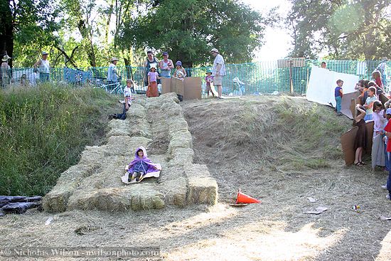Kids on hay bale slide