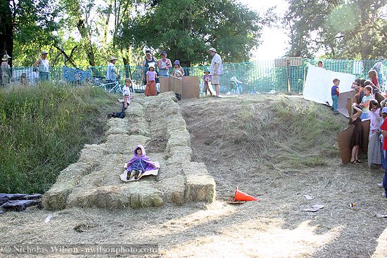 Kids on hay bale slide