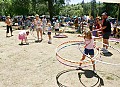 A girl spins four hula hoops