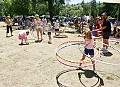 A girl spins four hula hoops