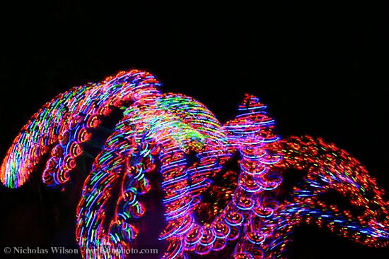 Dancer with spinning lights, time exposure