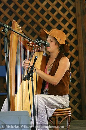 Phoenix (?) plays harp during open mike at the Hagler stage