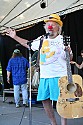 Wavy Gravy shows the guitar signed by many players which was raffled as a benefit for Seva Foundation's work against blindness