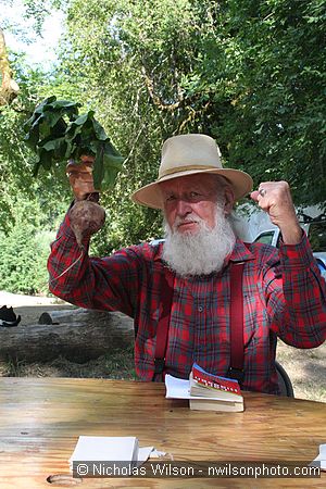 Utah Phillips with a beet for silencing noisy generators in camp