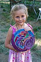 Joe Craven's daughter Hattie shows her painted silk creation backstage. Hattie played fiddle with the Laura Love Band Saturday night.