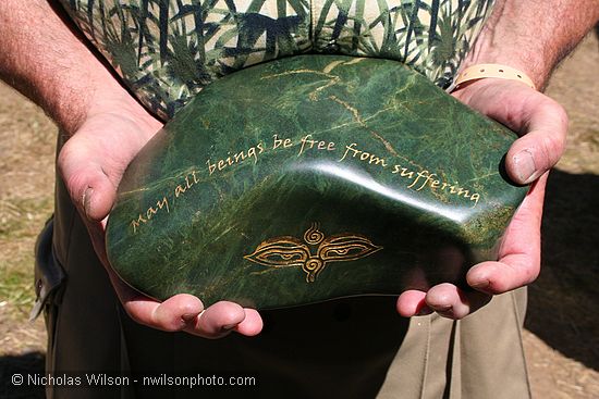 "May all beings be free from suffering" engraved in polished stone