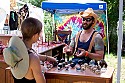 Craft vendor booths line the sides of the main concert meadow