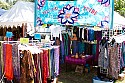 Craft vendor booths line the sides of the main concert meadow