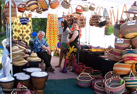 Craft vendor booths line the sides of the main concert meadow