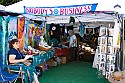 Craft vendor booths line the sides of the main concert meadow