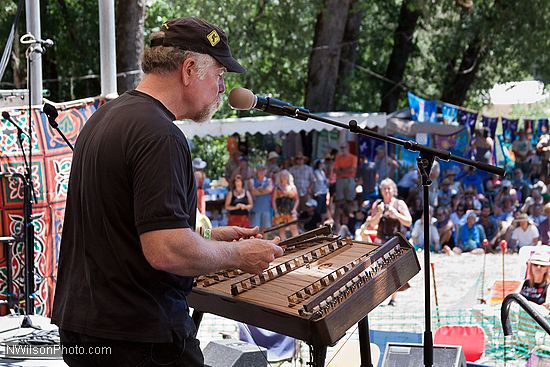 Multi-instrumentalist and singer John McCutcheon on the main stage Sunday morning playing a hammered dulcimer