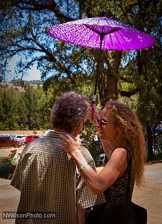 Stevie Coyle and friend backstage under a purple parasol.