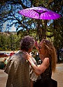 Stevie Coyle and friend backstage under a purple parasol.