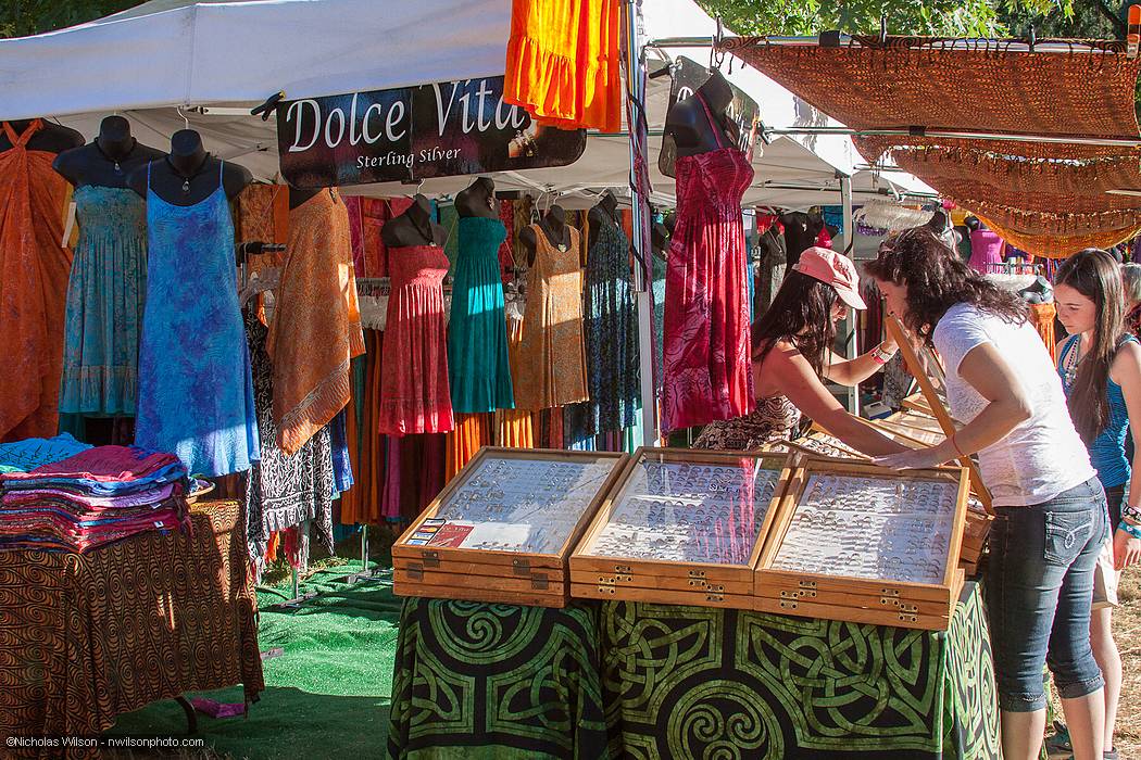 Vendor booths line the pathway to the main concert bowl.