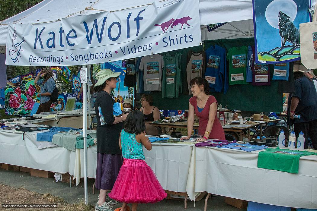 Kate Wolf's family booth has festival clothing and other items.