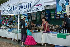 Kate Wolf's family booth has festival clothing and other items.