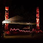 Illuminated tiki poles mark the path to the main concert bowl from the parking area.