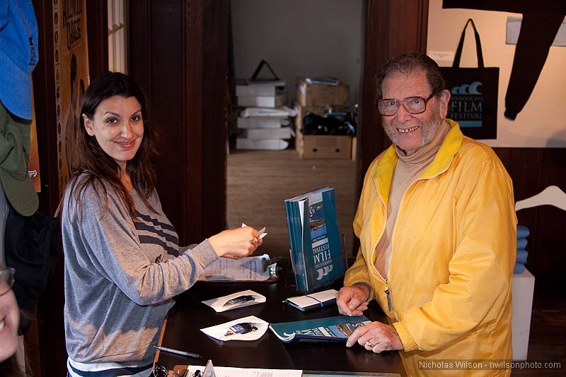 Retired lighting director and Mendocino Resident Rich Aguilar gets his film tickets from Maureen Leahy at the MFF box office.