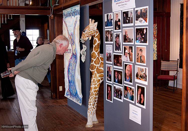 A visitor at the Oddfellows Hall box office checks out Nicholas Wilson's photo display from the first five seasons of the Mendocino Film Festival.