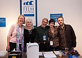 The filmmaker welcome desk with MFF Vice-President Ann Walker, volunteers Carole Freeman and James Sibbett, and two guest filmmakers.