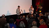 Les Blank holds the 2011 Maysles Award trophy as MFF advisor Jim McCullough and the audience applaud.