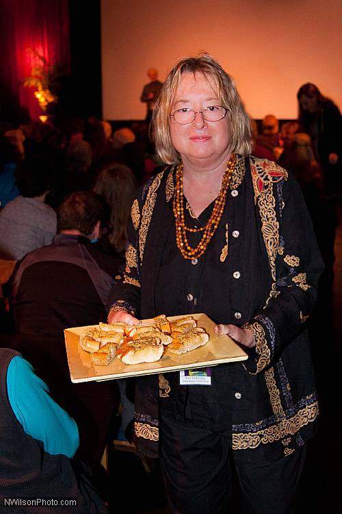 MFF Program Director Pat Ferrero serves freshly made garlic bread to audience members after a clip from Les Blank's film "Garlic Is As Good As Ten Mothers."