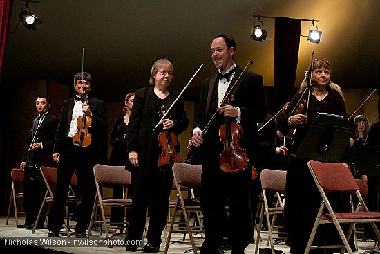 Festival orchestra members receive applause following Brahms' Symphony No. 4.