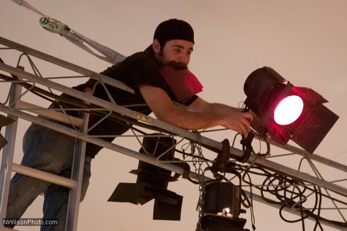 Nick Tringale adjusts a stage light.