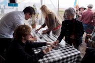 Julian signs his CDs for fans.