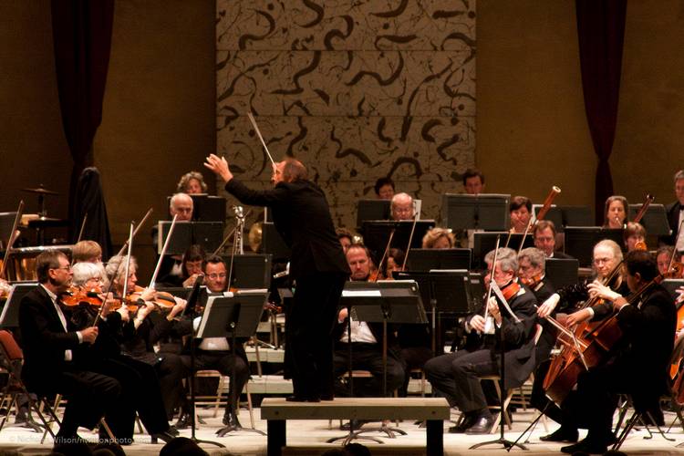 Allan Pollack conducts the orchestra.