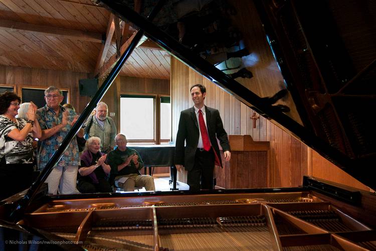 After several encores, Spencer Myer returns for a final bow at his concert at Preston Hall.