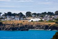 Town of Mendocino with the Mendocino Music Festival's big white 850-seat tent concert hall overlooking Mendocino Bay and the blue Pacific Ocean.