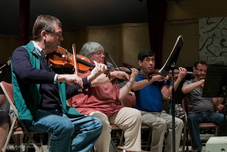 Leaders of the violin section in rehearsal for the final concert.