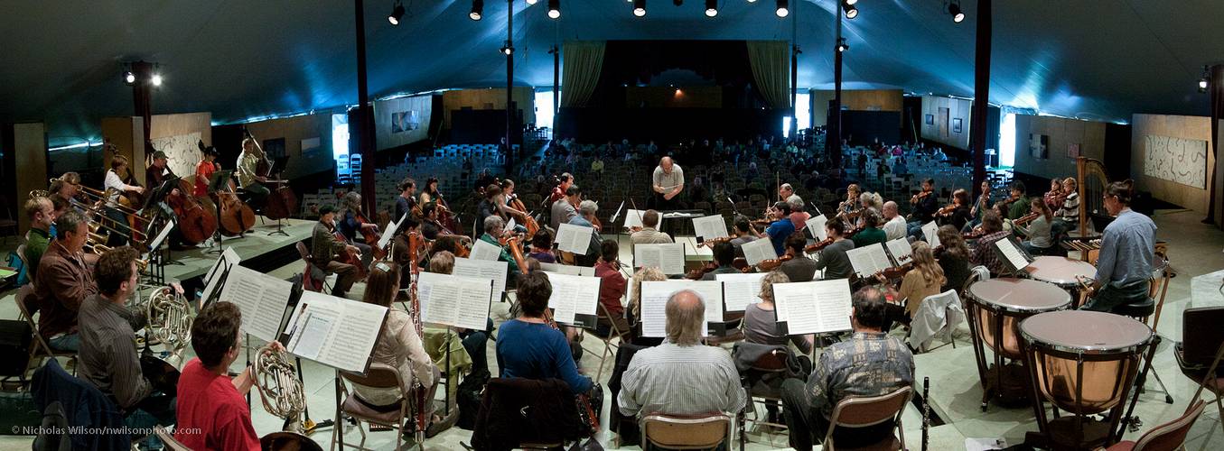 Panoramic view from rear of orchestra in rehearsal for the final concert.