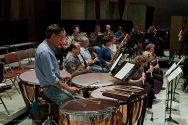 Timpanist Tyler Mack and the wind section in rehearsal of the final concert.