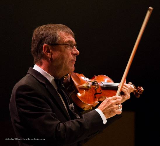 Concertmaster Roy Malan tunes the orchestra for the performance of Mahler's Song to the Earth.