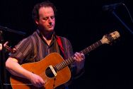 Eamon McElholm plays guitar with Solas.