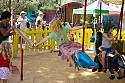 A carousel rider reaches for a brass ring