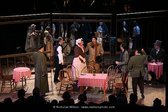 Mimi and Rodolfo join the others at Cafe Momus. The audience is seated at cafe tables like those on stage.