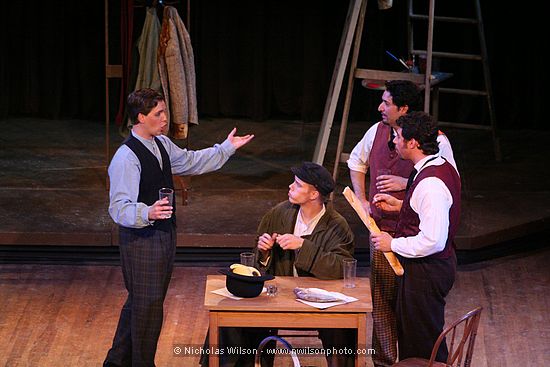 Schaunard, Colline, Rodolfo and Marcello share bread, wine and friendship.