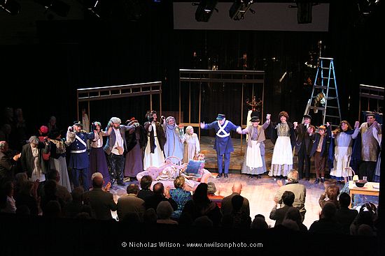 The chorus members take the first bow as the audience rises in a standing ovation.