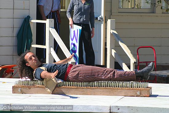 Flynn Creek Circus performer on a bed of nails.