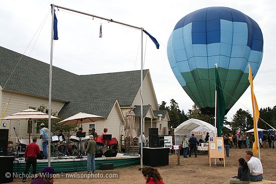 A hot air balloon prepares for takeoff as Kevin and the Coconuts  play.