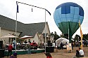 A hot air balloon prepares for takeoff as Kevin and the Coconuts  play.