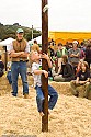 The popular greased pole climb offers elusive cash prizes.