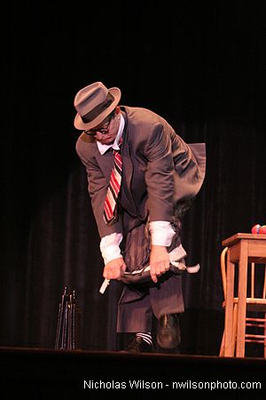 Bill Irwin does a quick costume change on stage at Cotton Auditorium, Fort Bragg CA