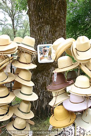 Display of hats and photographer's self-portrait